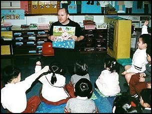 Andrew Orme reading in his son's kindergarten